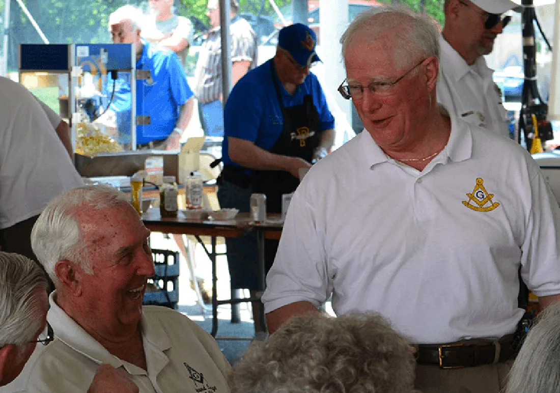 Older adult males chatting at a community event